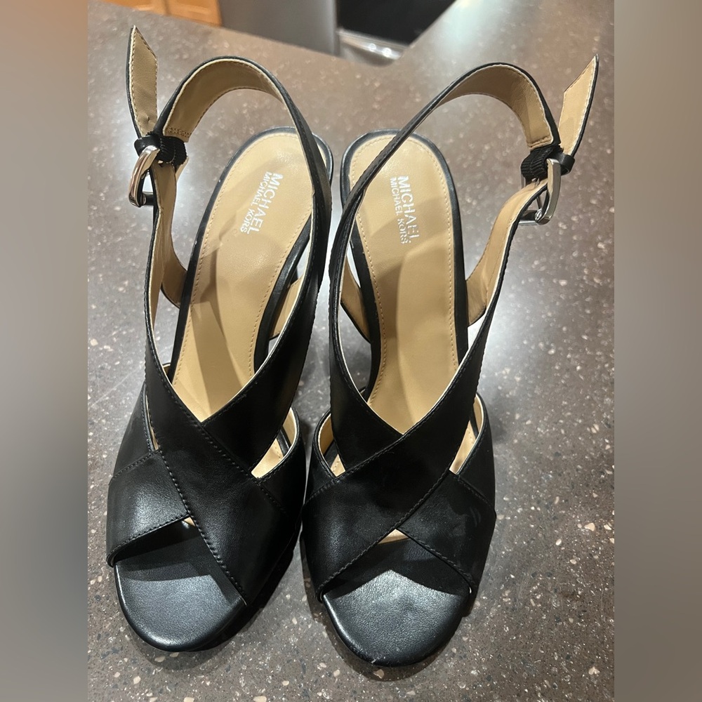 Michael Kors' Becky Leather Slingback Peep toe 3.5” crisscrossed buckle sandal.